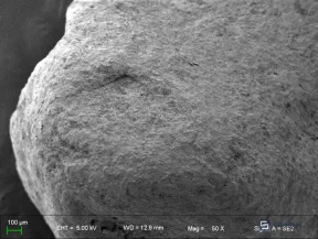 Figure 7: SEM image of raw manganese sand (a) showing intact surface structure before maturation