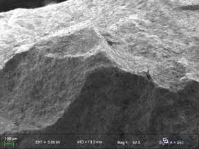 Figure 8: SEM image of matured manganese sand showing loose oxide deposits, increased porosity, and active surface sites developed through contact oxidation